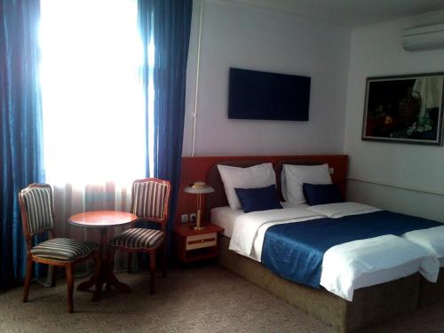特雷比涅莱奥塔尔酒店的酒店客房带一张床、一张桌子和椅子