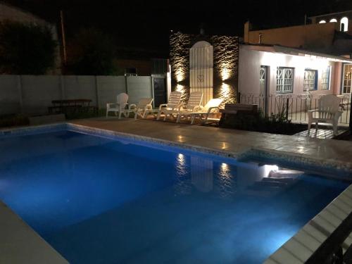 查斯科穆斯Hotel El Mirador的夜间在房子前面的游泳池