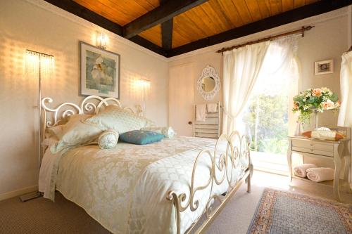 新普利茅斯蒂沃利寄宿家庭酒店的卧室配有白色的床和窗户。