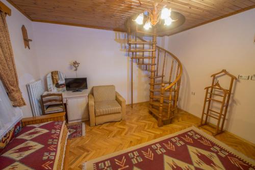 Beypazarı拜帕匝里伊派克科纳吉酒店的客厅设有螺旋楼梯和椅子