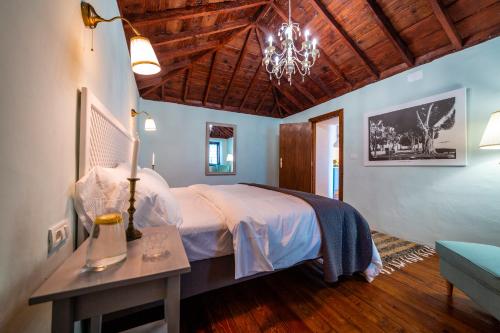 丰卡连特德拉帕尔马Casa Azul的一间卧室配有一张床和一张带台灯的桌子