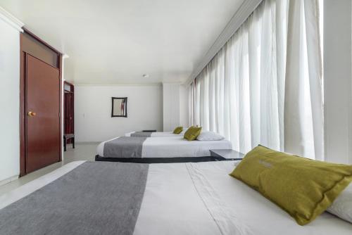 Ayenda 1030 Elegant Suite客房内的一张或多张床位