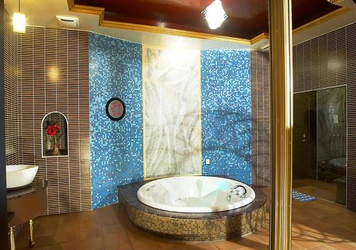 六龟御宿Motel-楠梓馆的带浴缸和盥洗盆的大浴室