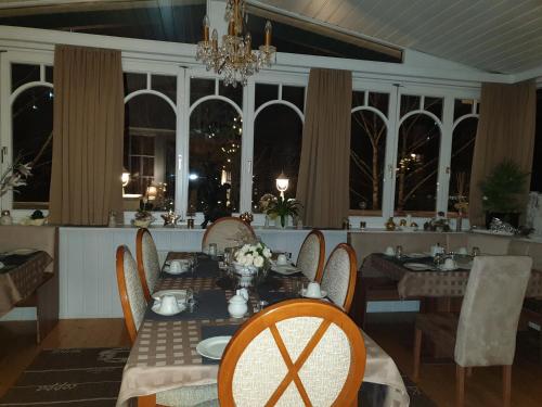 阿德蒙特伊丽莎白别墅酒店的一间带桌椅和窗户的用餐室