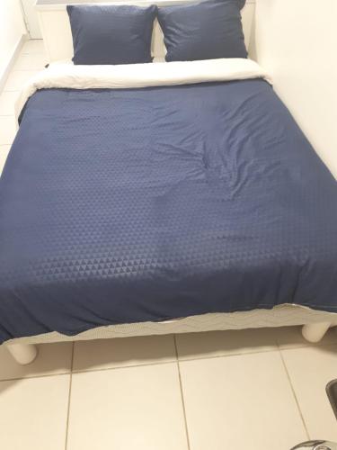 阿维尼翁studio climatisé的床上有蓝色的棉被