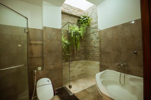 广义Tuyet Suong Villa Hotel的带淋浴、浴缸和卫生间的浴室