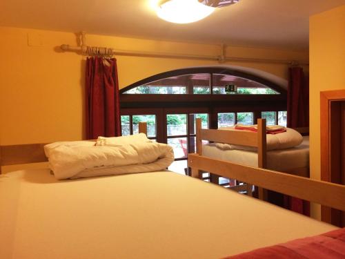 波尔托罗波尔托罗欧罗巴旅舍的一间卧室设有两张床和窗户。
