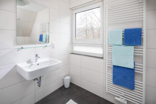 诺德奈Deniz - Blick的白色的浴室设有水槽和窗户。
