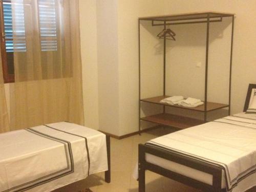 明德卢Residencial Monte Cara的酒店客房,设有两张床和镜子