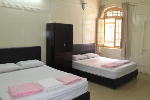 老槟城酒店 - 庄路客房内的一张或多张床位