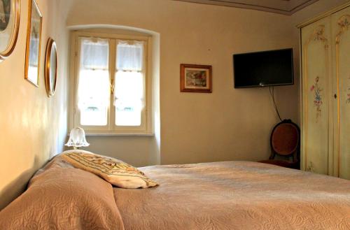 卡萨尔扎利古雷I Fiori di Miranda的一间卧室配有一张带枕头和窗户的床