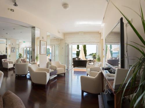 萨度拉德波斯卡杜布罗夫尼克群岛酒店的一间设有白色椅子和电视的等候室