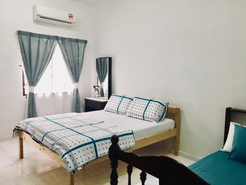 马六甲巴克卡迪因达旅舍的一间卧室设有一张床和一个窗口