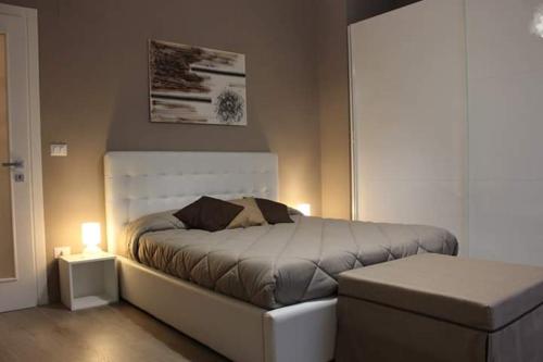 费兰迪纳Le Antiche Vie的一间卧室配有一张带白色床头板的床