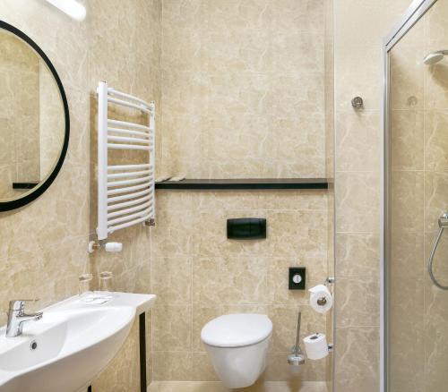 克拉科夫Metropolo by Golden Tulip Krakow的浴室配有卫生间、盥洗盆和淋浴。