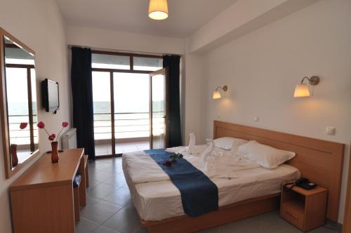 马马亚蓝色海滩一室公寓的一间卧室设有一张大床,享有海景