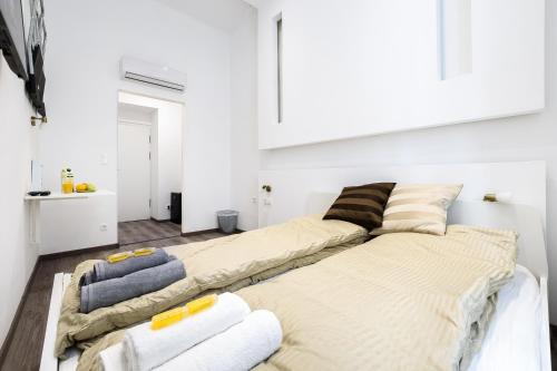 布达佩斯Annabelle Downtown Apartments的白色客房内的两张床和毛巾