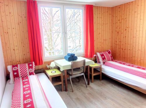 维尔德豪斯Galluszentrum的客房设有两张床、一张桌子和一扇窗户。