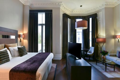 伦敦伦敦女王门辉盛阁国际公寓的一间带大床的卧室和一间客厅