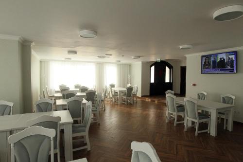 百乐费利克斯Pensiunea Hanna的一间设有白色桌椅的用餐室