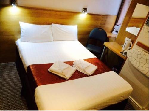 伦敦西克伦威尔酒店的酒店客房配有两张床和一张书桌