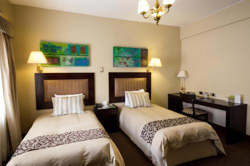 卡哈马卡温德姆科斯塔朗晴酒店客房内的一张或多张床位