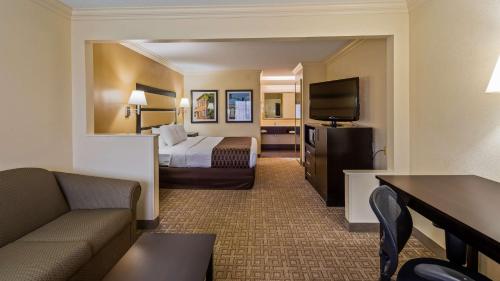 拜伦拜伦贝斯特韦斯特酒店的配有一张床和一台平面电视的酒店客房