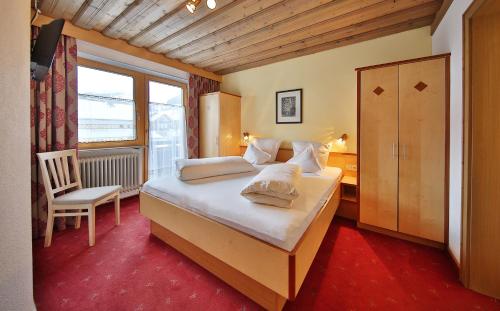 瑟弗浩斯欧泊拉赫尔公寓的一间卧室配有一张带椅子的床和一扇窗户