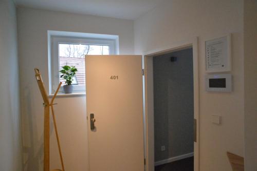 格罗斯贝伦Grey House Apartments Grossbeeren的窗户客房内的白色冰箱