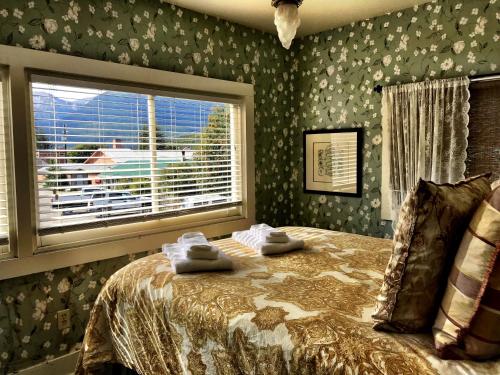 史凯威Historic Skagway Inn的一间卧室配有带毛巾的床