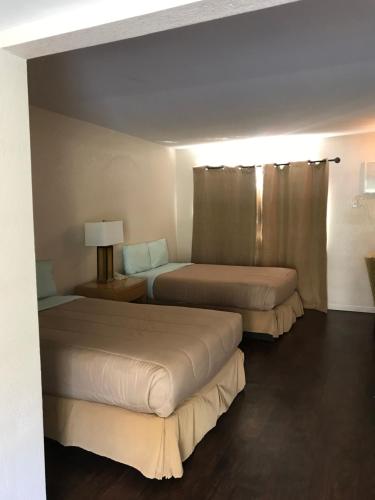棕榈泉棕榈泉德罗斯瑞斯汽车旅馆的酒店客房设有两张床和窗户。