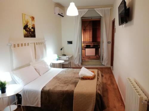 卡尔塔吉罗Il Duomo Home的卧室配有一张白色的大床和一张桌子