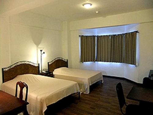 加拉班金宝殿酒店的酒店客房配有两张床和一张书桌