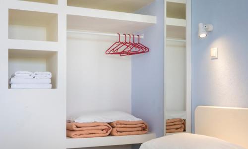 拉瑟玛塔萨图斯公寓的浴室设有衣柜和架子上的毛巾