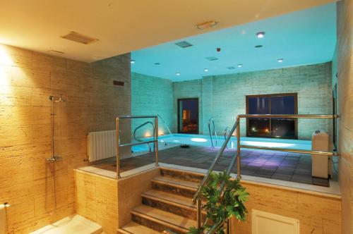 哈兰迪雅·德·拉·维尔奧地利的唐胡安乡村酒店及Spa的游泳池位于一间带浴缸的浴室内