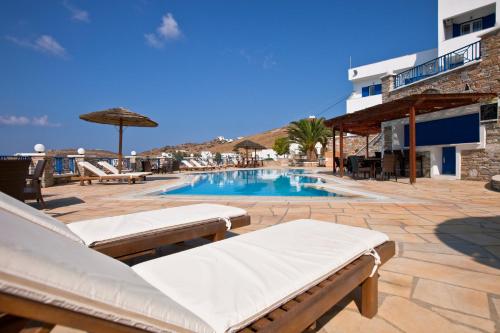 伊奥斯乔拉赫尔墨斯旅馆的一座游泳池,旁边设有两张躺椅