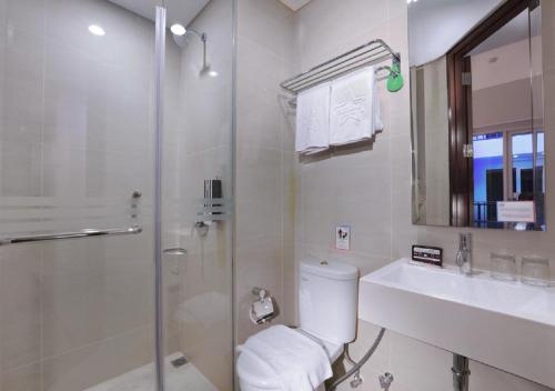 库塔日落路名望酒店的带淋浴、卫生间和盥洗盆的浴室