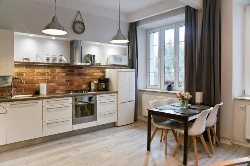 克拉科夫Cichy apartament w centrum Krakowa Salwator的厨房配有桌椅和冰箱。