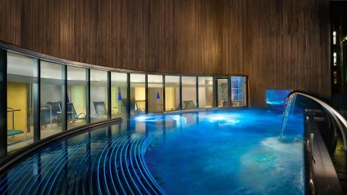爱丁堡喜来登大酒店&SPA的大型建筑内的大型游泳池,设有游泳池