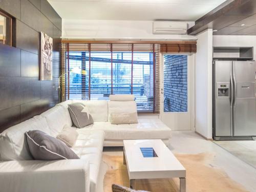 塔库沃里Holiday Home Tahko spa suites orange a 4- price inclu by Interhome的客厅配有白色沙发和冰箱。