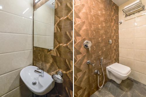 孟买Hotel Sea Grand, Colaba的一间带水槽、卫生间和淋浴的浴室