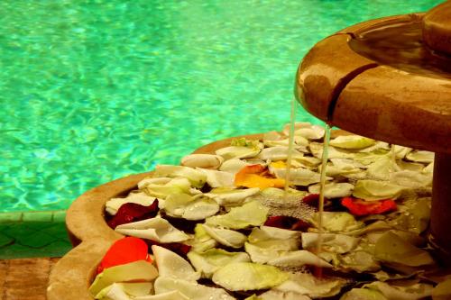 马拉喀什雷亚德夏玛套房酒店及Spa的游泳池旁的披萨被酱油滴着