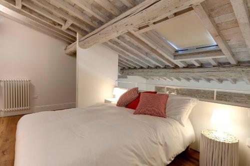 佛罗伦萨Mamo Florence - Mattonaia Apartment的卧室配有带红色枕头的大型白色床
