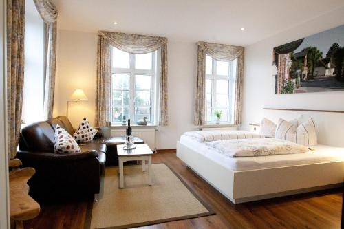 内贝尔Hotel Restaurant Friedrichs的卧室配有一张白色大床和一把椅子