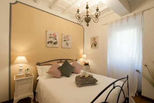 佛罗伦萨Belvedere Suite Florence的卧室配有一张带吊灯的大型白色床。