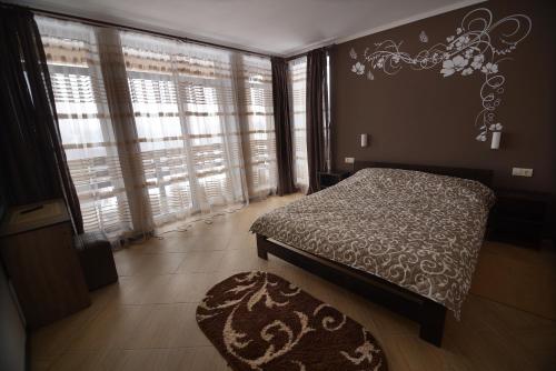 亚布卢尼齐亚Ozone minihotel的一间卧室设有床、窗户和地毯。