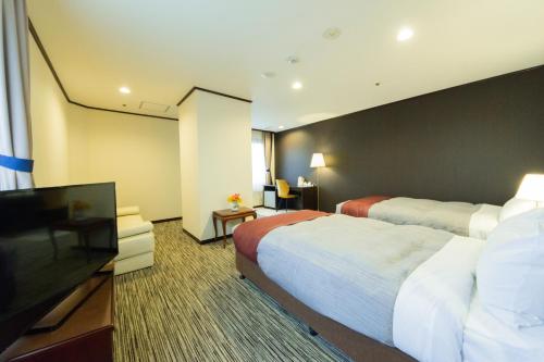 紫雲閣东松山花园酒店客房内的一张或多张床位