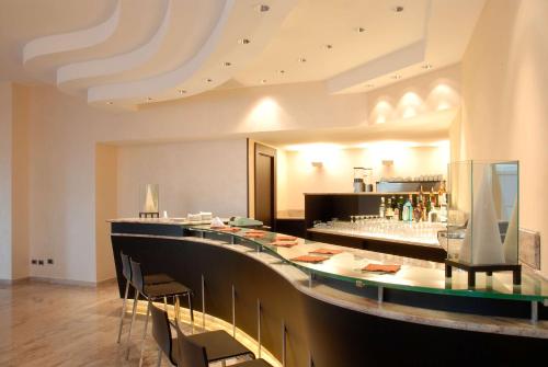 弗利San Giorgio, Sure Hotel Collection by Best Western的餐厅设有长长的酒吧,配有凳子