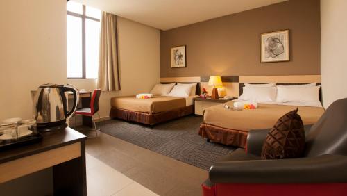 吉隆坡LEO快捷酒店 的酒店客房,设有两张床和一张沙发