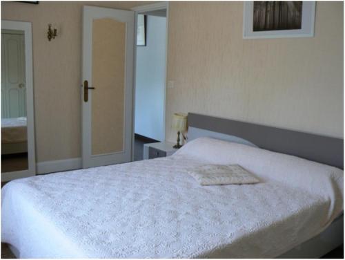 克莱西杜红磨坊乡间旅馆的卧室配有白色的床和镜子